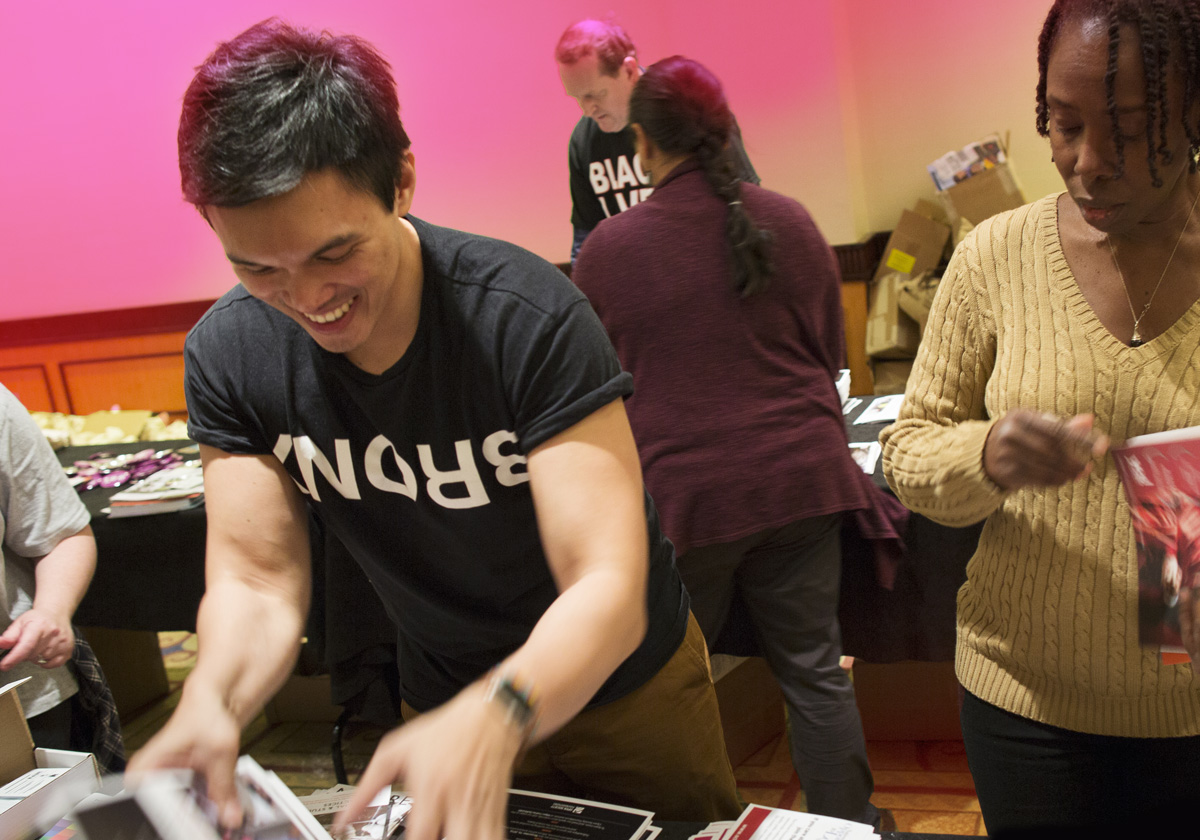 People gathered around tables packing materials.