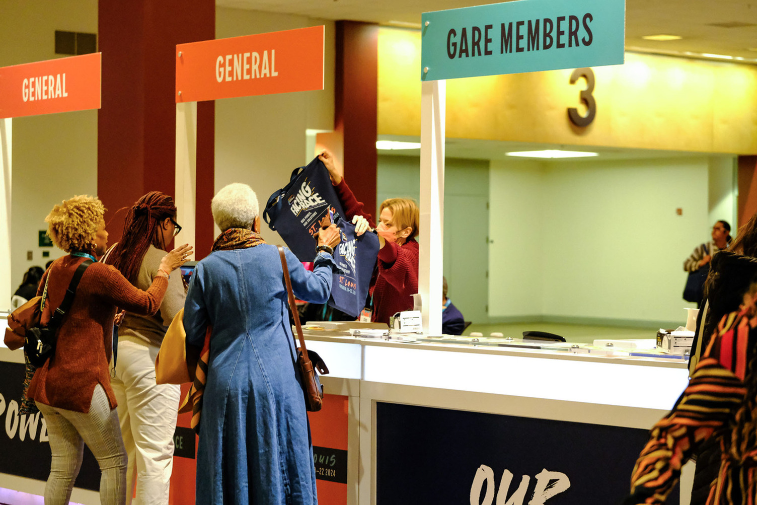 People at Facing Race/GARE Membership Meeting registration desk.