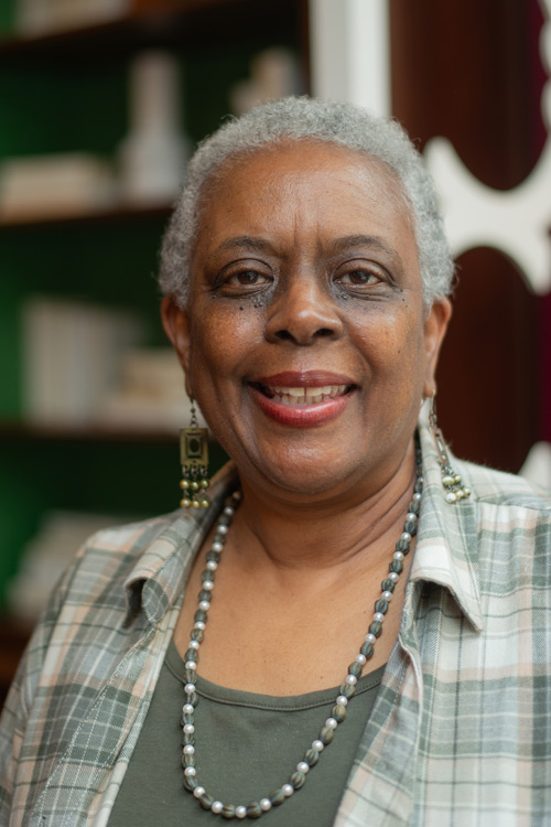 Smiling person wearing shades of green.
