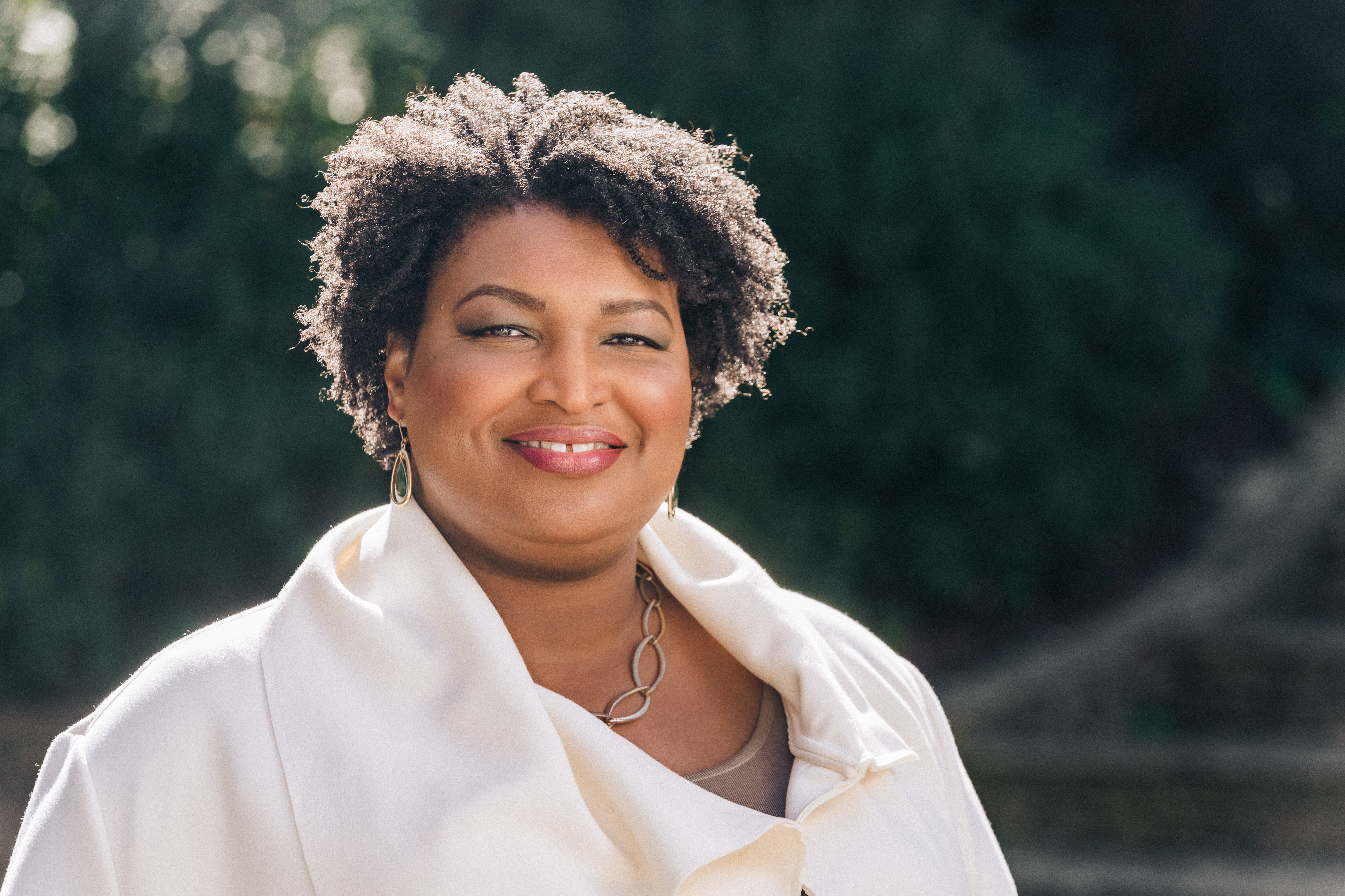 Photo of Stacey Abrams smiling on a sunny day