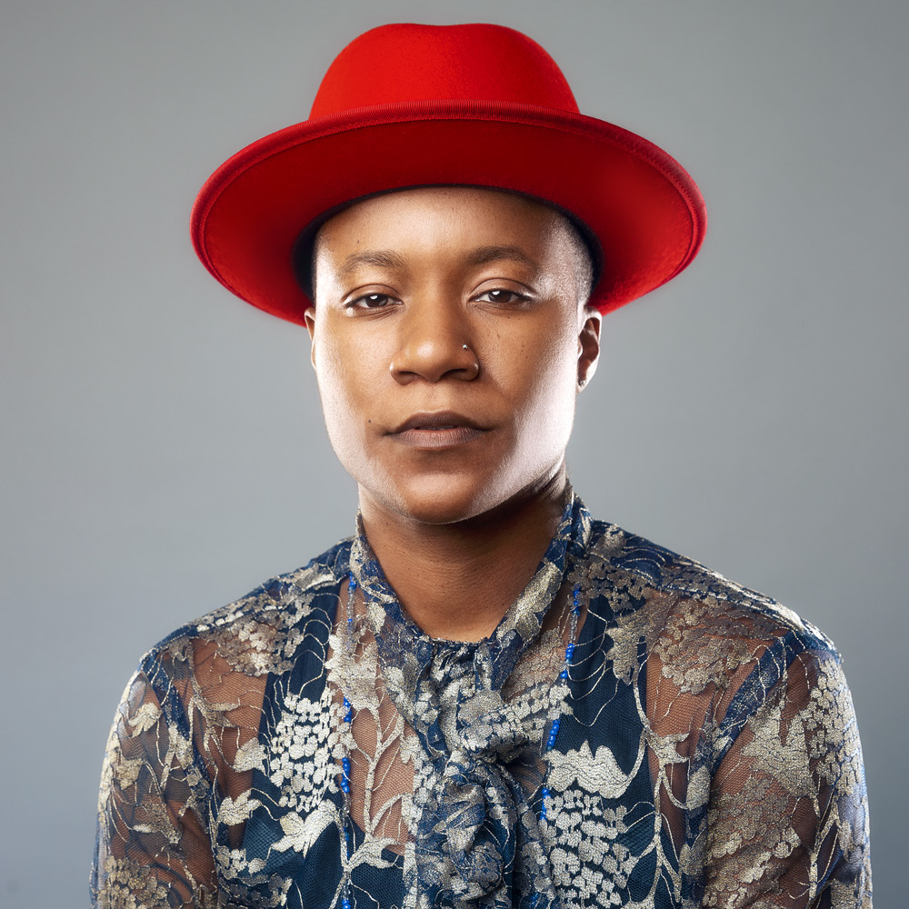 DJ Boogie wearing a red hat.