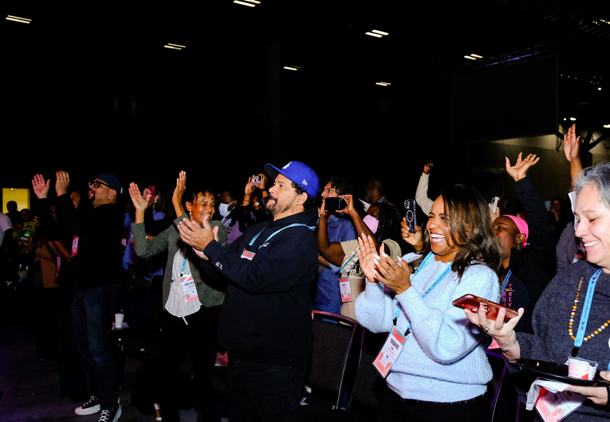 Happy people standing and applauding.