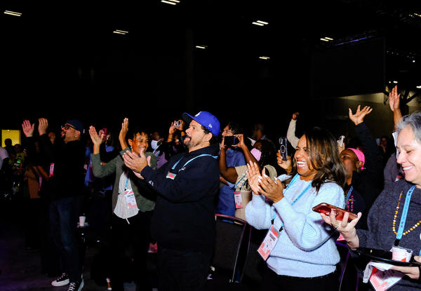 Happy people standing and applauding.