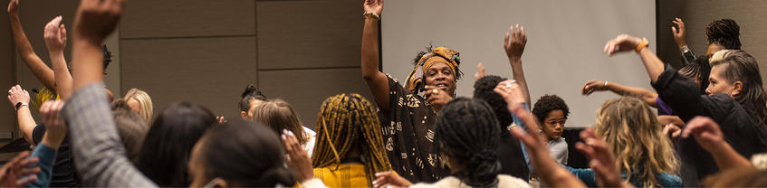 People with one arm raised in the air.