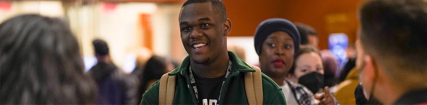 Smiling person at front of line.