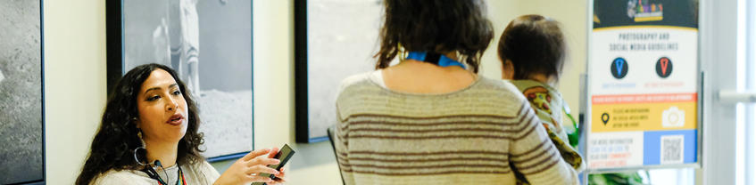 Person carrying child into a room.